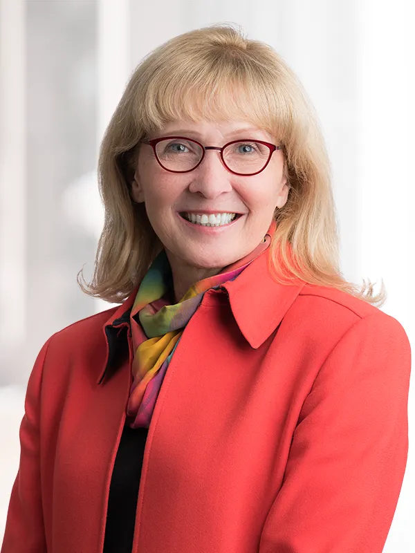 A professional headshot photo of Ruth Binger