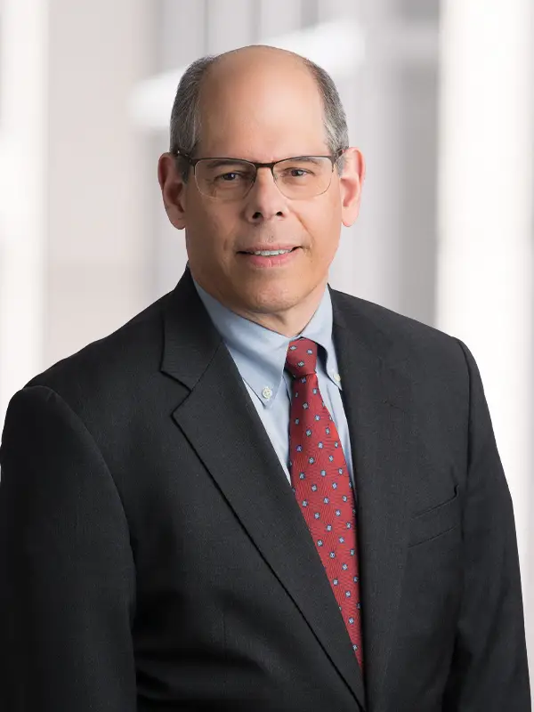 Professional head shot of attorney Tom DeWoskin